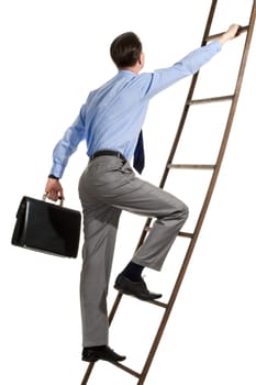 Portrait of businessman with briefcase climbing on staircase