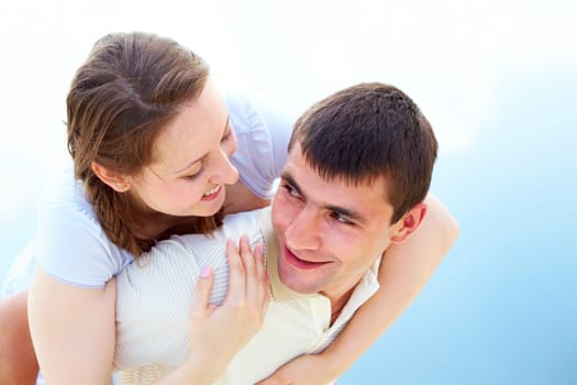 Photo of happy girl embracing her boyfriend and having fun