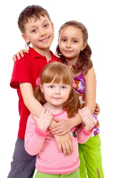 Portrait of cute girl being embraced by her friends behind