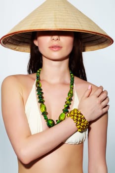 Portrait of a young girl in bikini and cone hat