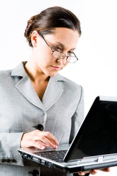 Portrait of businesswoman typing on laptop over white background