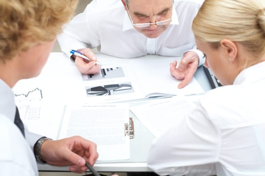 Image of partners working with documents at business meeting