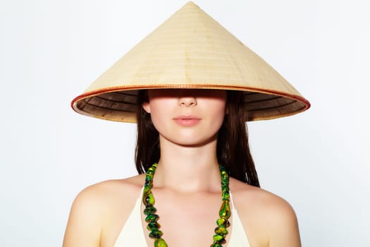 Portrait of a young girl in Vietnamese hat