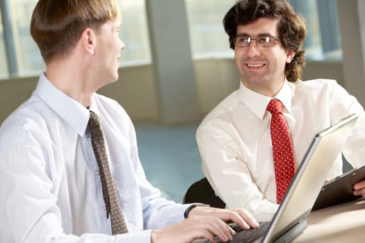 Image of smart businessman explaining new strategy to his partner at meeting