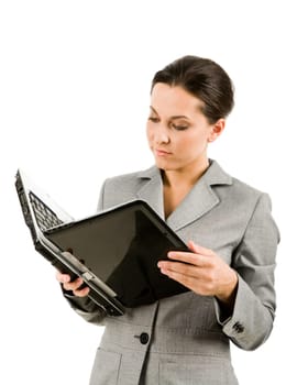 Portrait of businesswoman holding laptop and reading information from its display