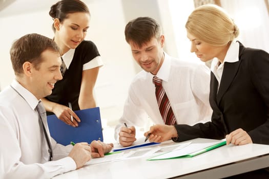 Portrait of busy people discussing new project or working plan