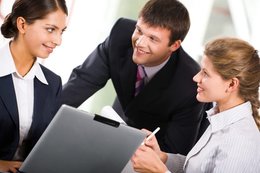 Portrait of three  white collar worker interacting at business meeting