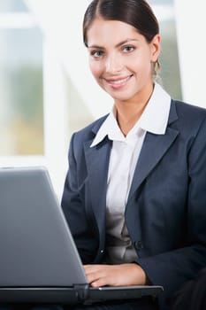 Young elegant business woman looking at camera