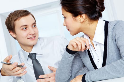 Successful colleagues discussing plans in office