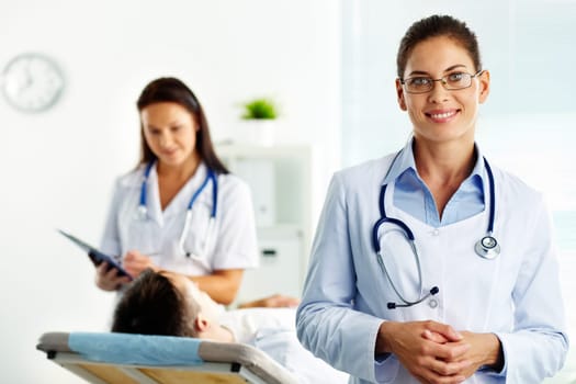 Portrait of confident female doctor looking at camera in hospital
