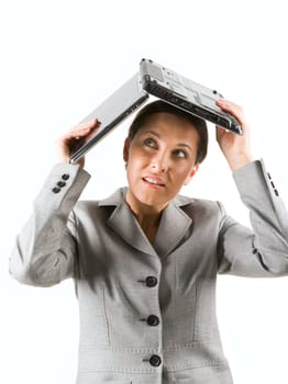 Portrait of businesswoman protecting her head by laptop on white background