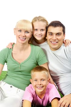 Portrait of girl embracing her parents with brother lying under them