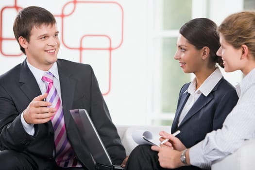 Group of three young business people are discussing new plan