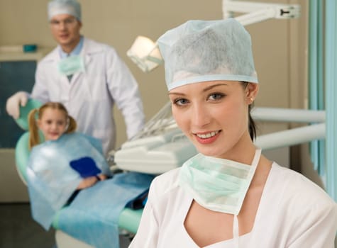 Beautiful woman wearing uniform looking at camera with smile on background of workplace