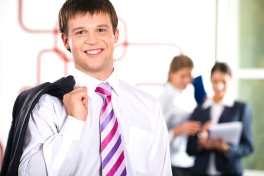 Image of business man with coat thrown through his shoulder
