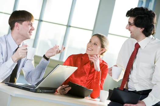 Photo of business people discussing a new idea during coffee break
