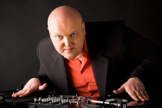 Portrait of big man with his hands on vynil records