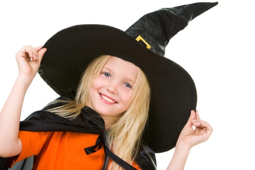 Portrait of girl in witch costume posing before camera