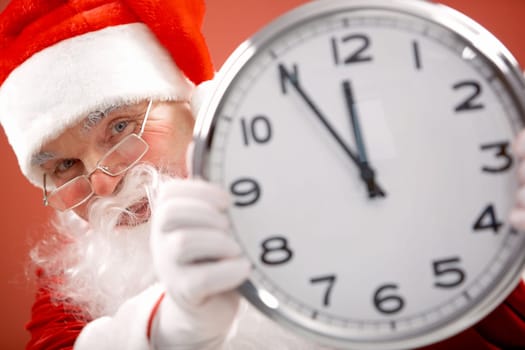 Photo of Santa holding clock showing five minutes to midnight
