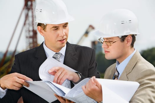 Successful architect is explaining  a conditions of project to the customer