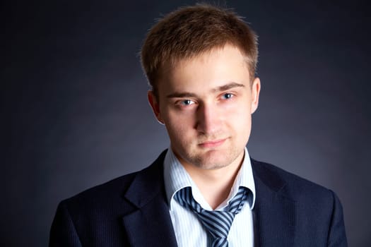 Portrait of young handsome businessman looking at camera