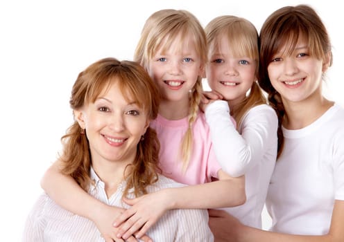 A young family of four looking at camera