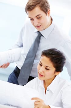 Portrait of two architects looking document at meeting