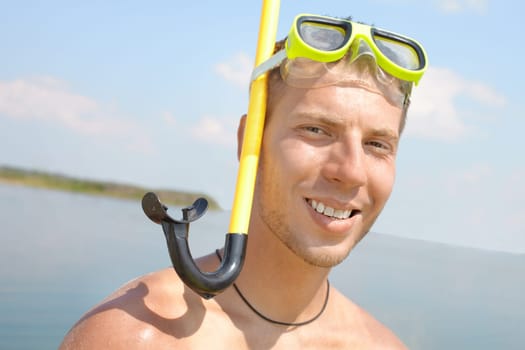 Portrait of a man in scuba looking at camera and smiling