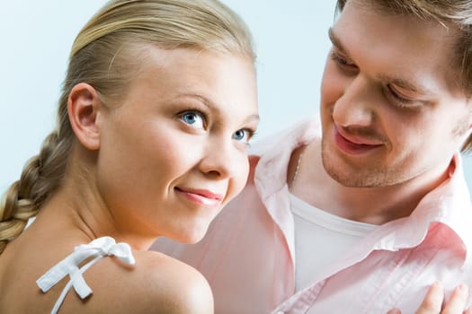 Image of cute girl staring upwards while handsome man looking at her