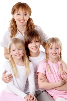 A young family of four females looking at camera