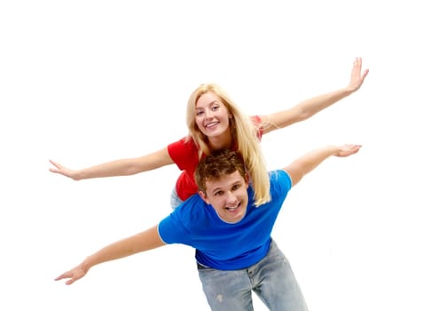 Photo of happy man giving piggyback to his girlfriend while both looking at camera