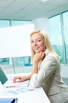 Portrait of pretty secretary looking at camera in office