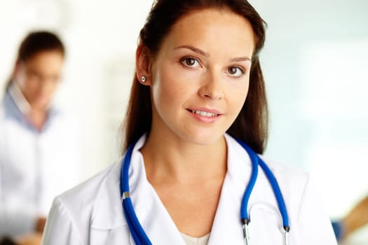 Portrait of confident female doctor looking at camera in hospital