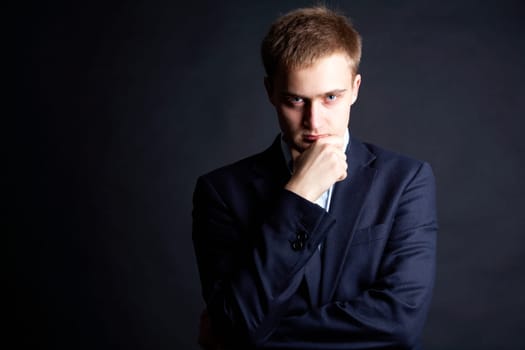 Portrait of serious businessman looking at camera