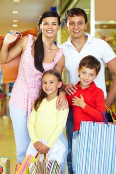 Portrait of happy parents and children during shopping