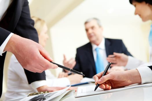 Close-up of business partners hands during discussion in working environment