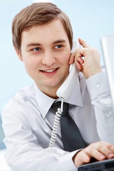 Portrait of smiling agent speaking by telephone