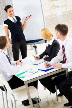 Photo of happy businesswoman sharing her ideas by whiteboard with partners