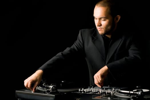 Portrait of handsome deejay playing club music