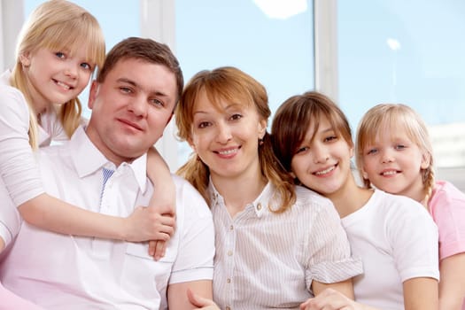 A young friendly family looking at camera