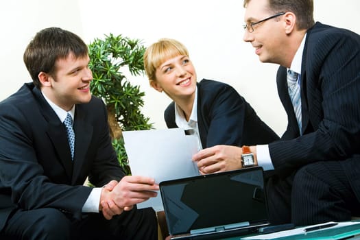 Business man passing the documents to his partner at meeting