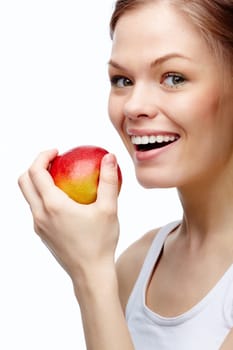 Portrait of a young girl biting an apple