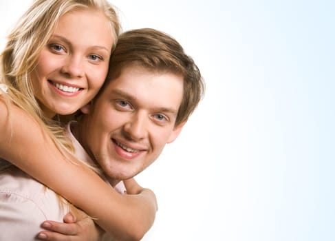 Photo of happy couple embracing and looking at camera with smiles