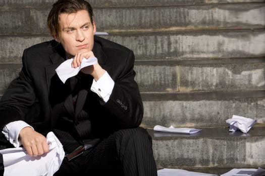 Portrait of thoughtful business man touching his chin and looking aside
