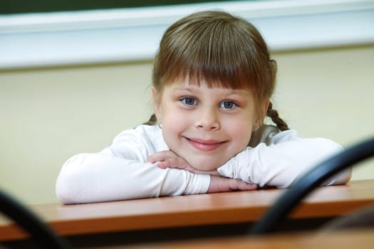 Portrait of smart schoolgirl looking at camera with smile