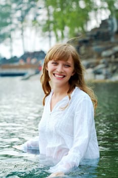 Portrait of pretty girl having fun in water during summer vacation