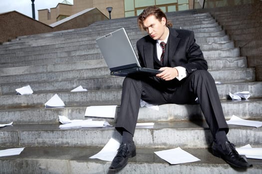 Portrait of serious business leader with laptop looking at its monitor