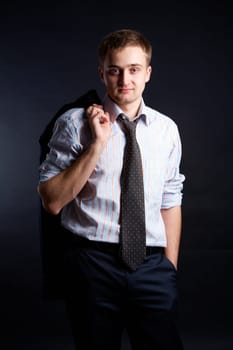 Portrait of stylish businessman looking at camera from darkness