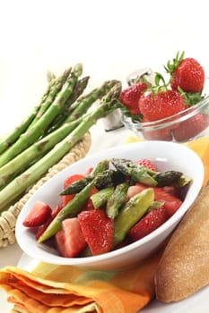 a bowl of asparagus and strawberry salad with fried green asparagus