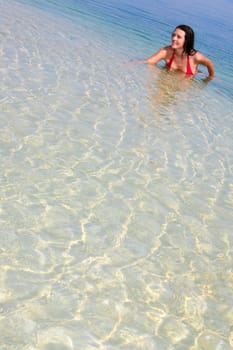 Image of happy pretty woman swimming in a lake